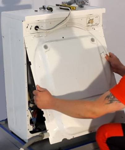Remove the back wall of the washing machine to access the pump.